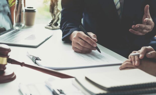 laywer negotiating contract with a gavel on their desk