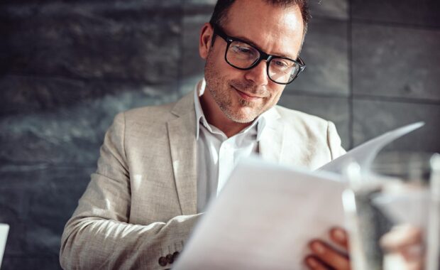 small business owner reviewing contract in a coffee shop