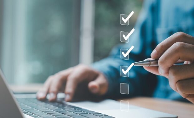 businessman use pen to tick correct sign mark in checkbox for quality document control checklist