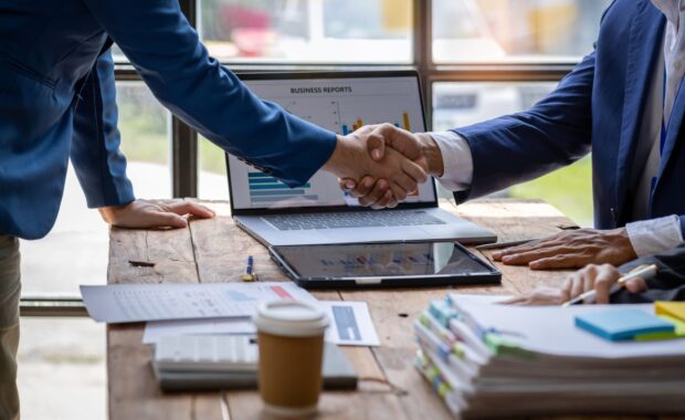 Federal contractor securing deal by shaking hand with client